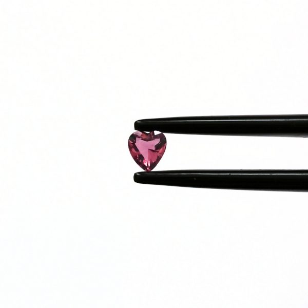 A photo of the crown area of the pink tourmaline against a white background