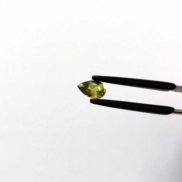 A photo of the crown area of the green peridot against a white background