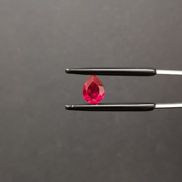 A photo of the crown area of the lab grown red ruby against a black background