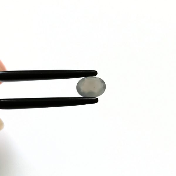 A photo of the crown area of the grey moonstone against a white background