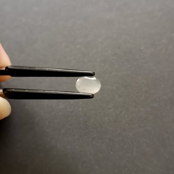 A photo of the crown area of the grey moonstone against a black background