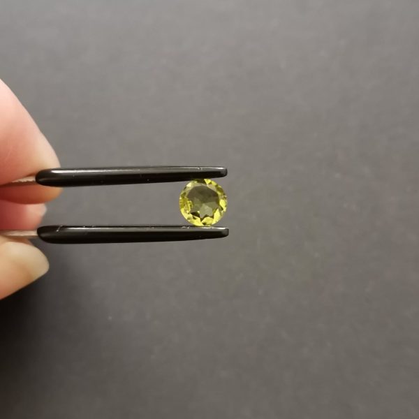 A photo of the crown area of the green peridot against a black background
