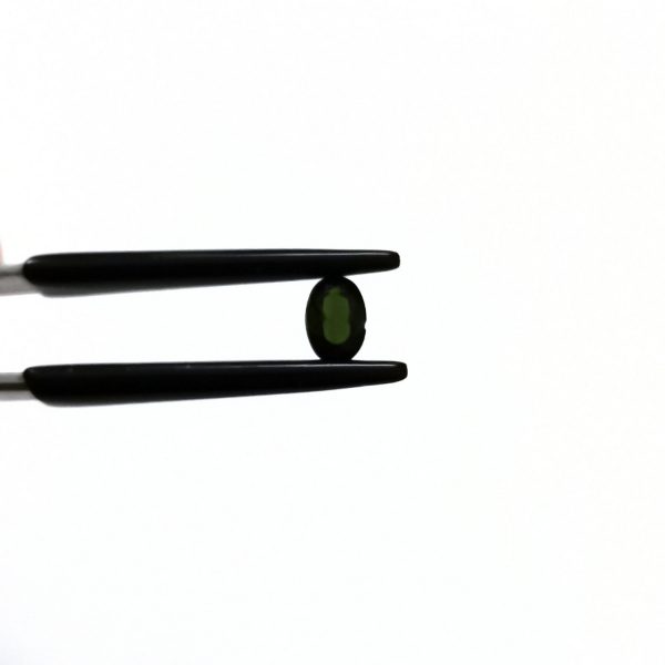 A photo of the crown area of the green tourmaline against a white background