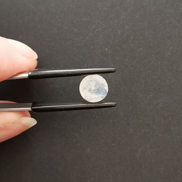 A photo of the crown area of the white moonstone against a black background