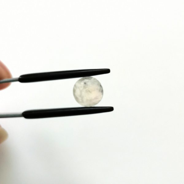 A photo of the crown area of the white moonstone against a white background