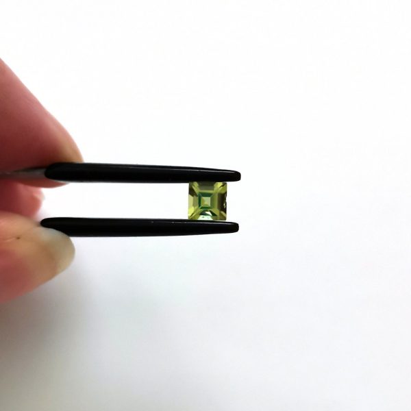 A photo of the crown area of the green peridot against a white background
