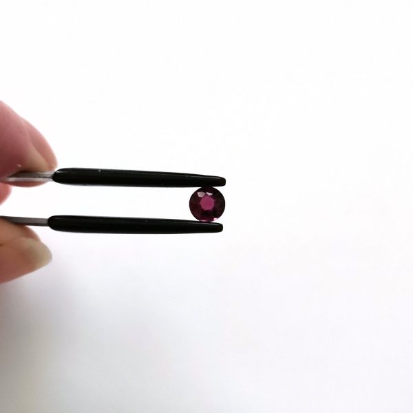 A photo of the crown area of the pink tourmaline against a white background
