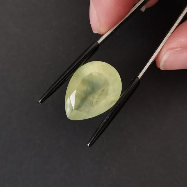 A photo of the crown area of the pale green prehnite against a black background