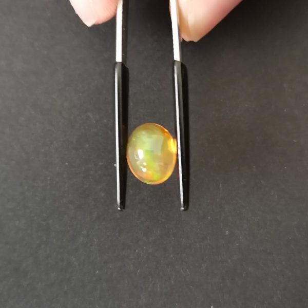 A photo of the crown area of the orange fire opal against a black background