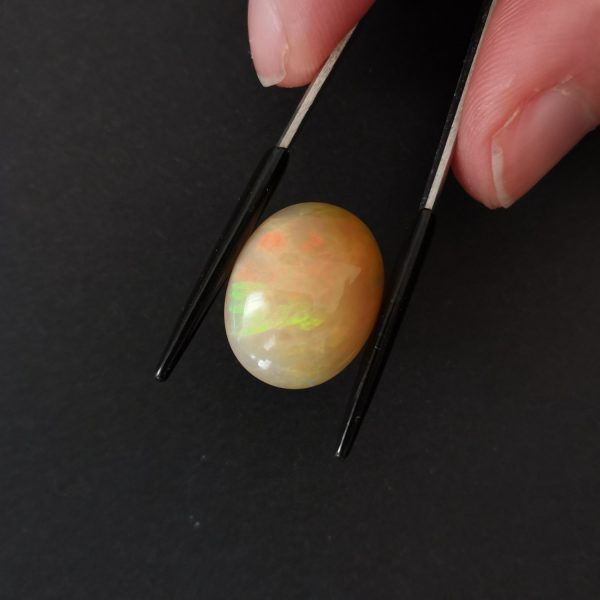 A photo of the crown area of the orange and cream opal against a black background