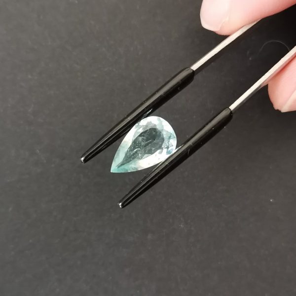 A photo of the crown area of the slightly greenish blue aquamarine against a black background