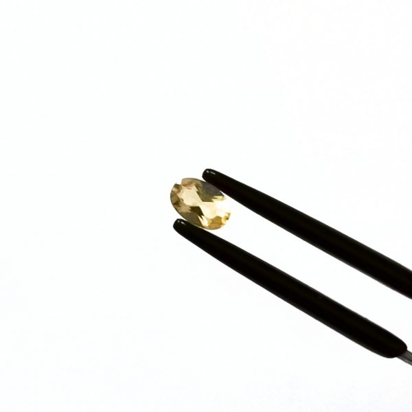 A photo of the crown area of the golden beryl against a white background