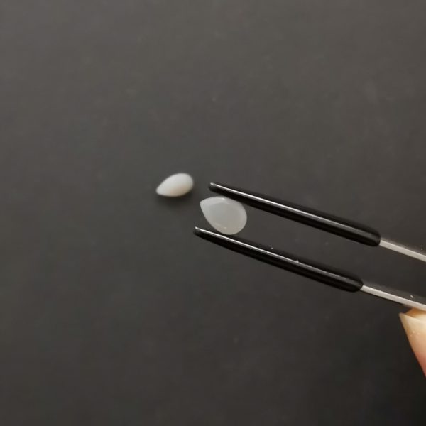A photo of the crown area of the grey moonstone against a black background