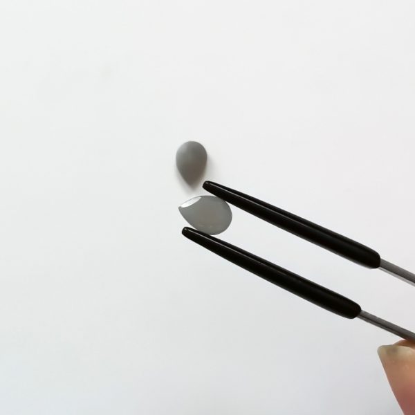 A photo of the crown area of the grey moonstone against a white background