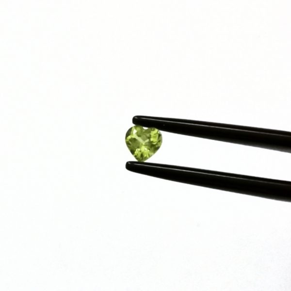 A photo of the crown area of the green peridot against a white background