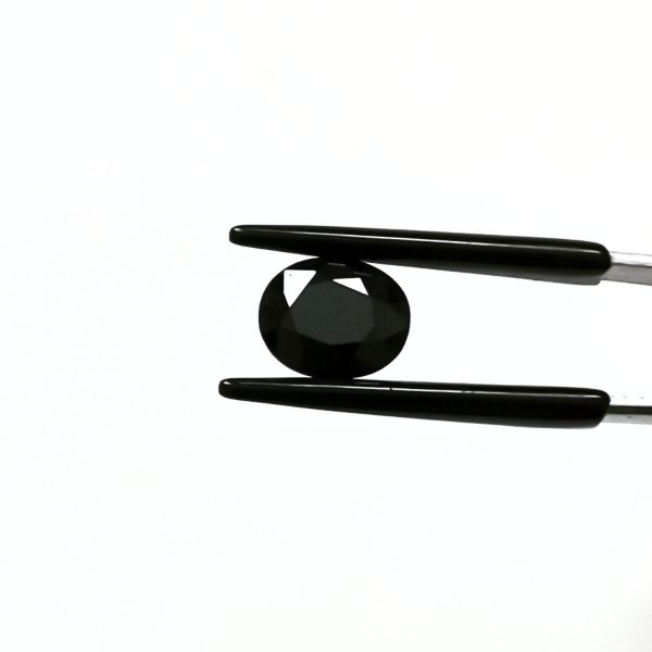 A photo of the crown area of the black sapphire against a white background
