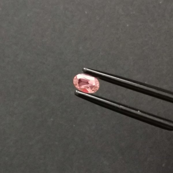 A photo of the crown area of the pink tourmaline against a black background