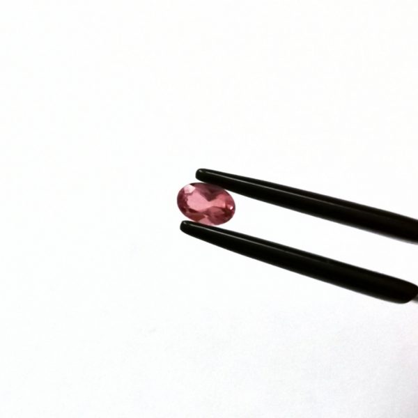 A photo of the crown area of the pink tourmaline against a white background