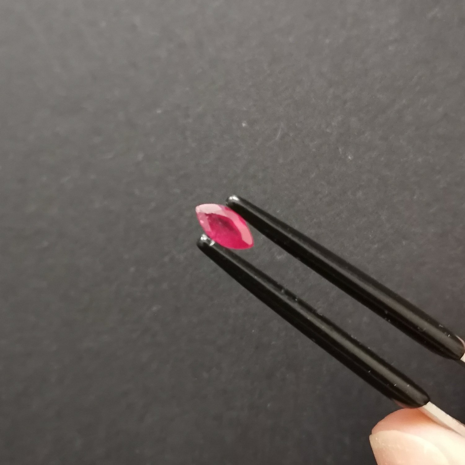 A photo of the crown area of the red ruby against a black background