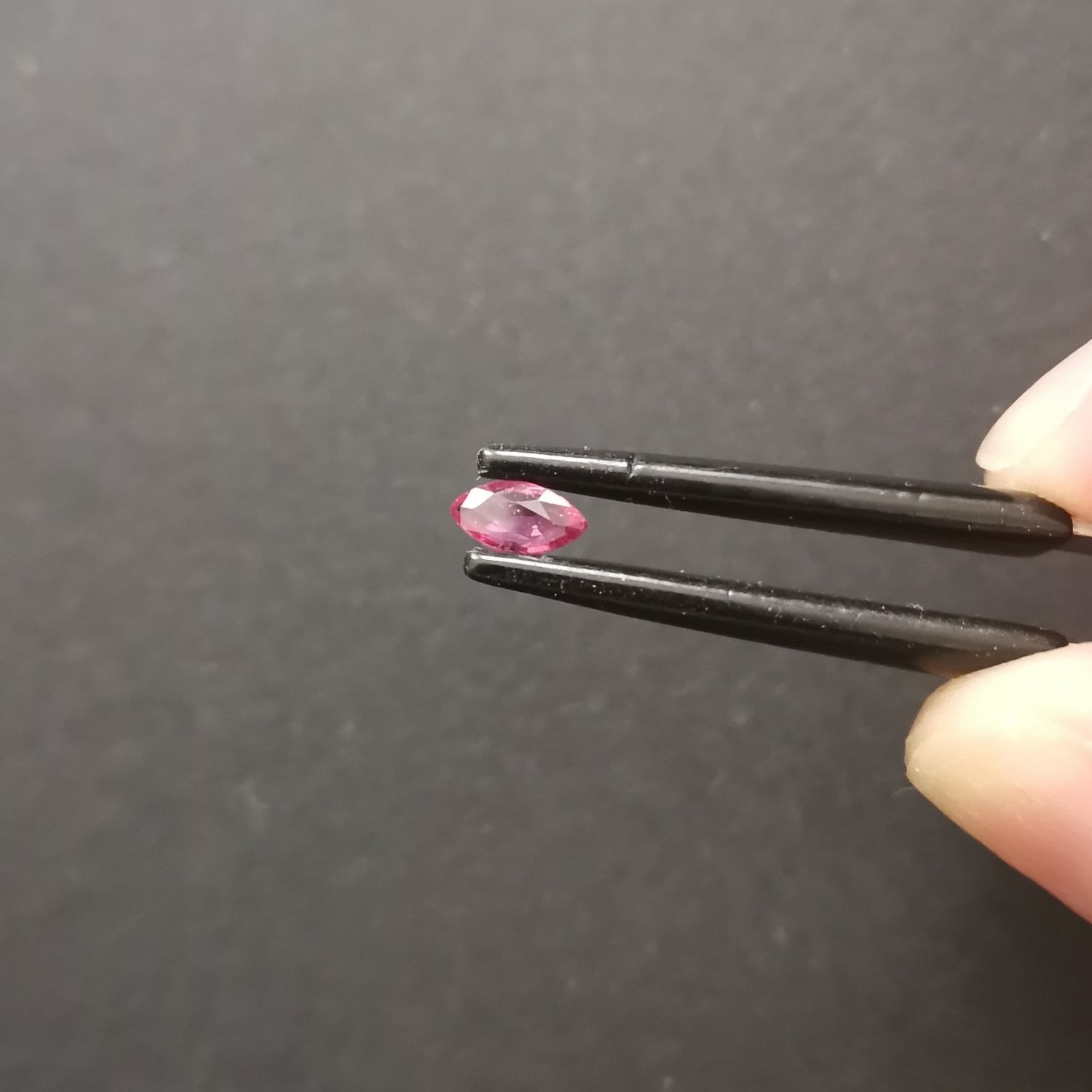 A photo of the crown area of the red ruby against a black background