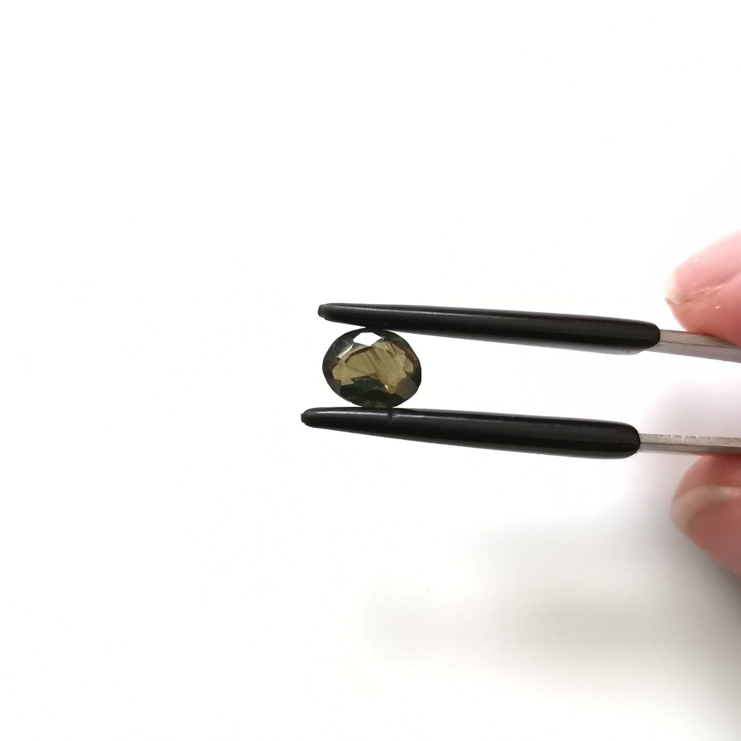 Crown view of the faceted zircon oval against a white background.