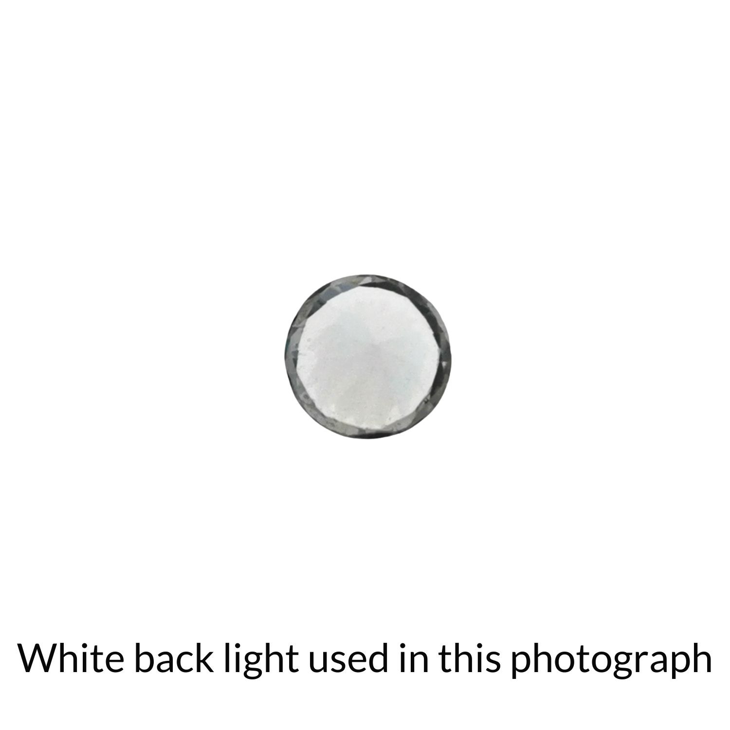 The faceted round zircon back-lit to highlight inclusions.