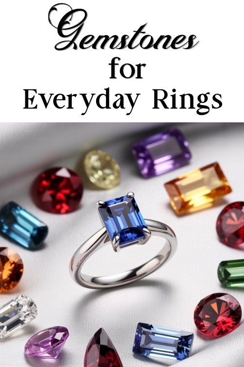 A silver ring with a large blue gemstone is surrounded by various colorful gems on a white surface. Text above reads "Gemstones for Everyday Rings."