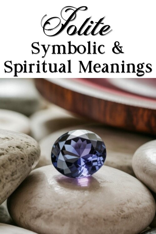 A polished Iolite gemstone rests on smooth pebbles, exuding a calming vibe. Above, elegant text reads "Iolite Symbolic & Spiritual Meanings."